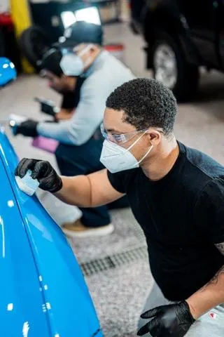Certified detailer applying ceramic coating to a customer vehicle in Lewisville, NC